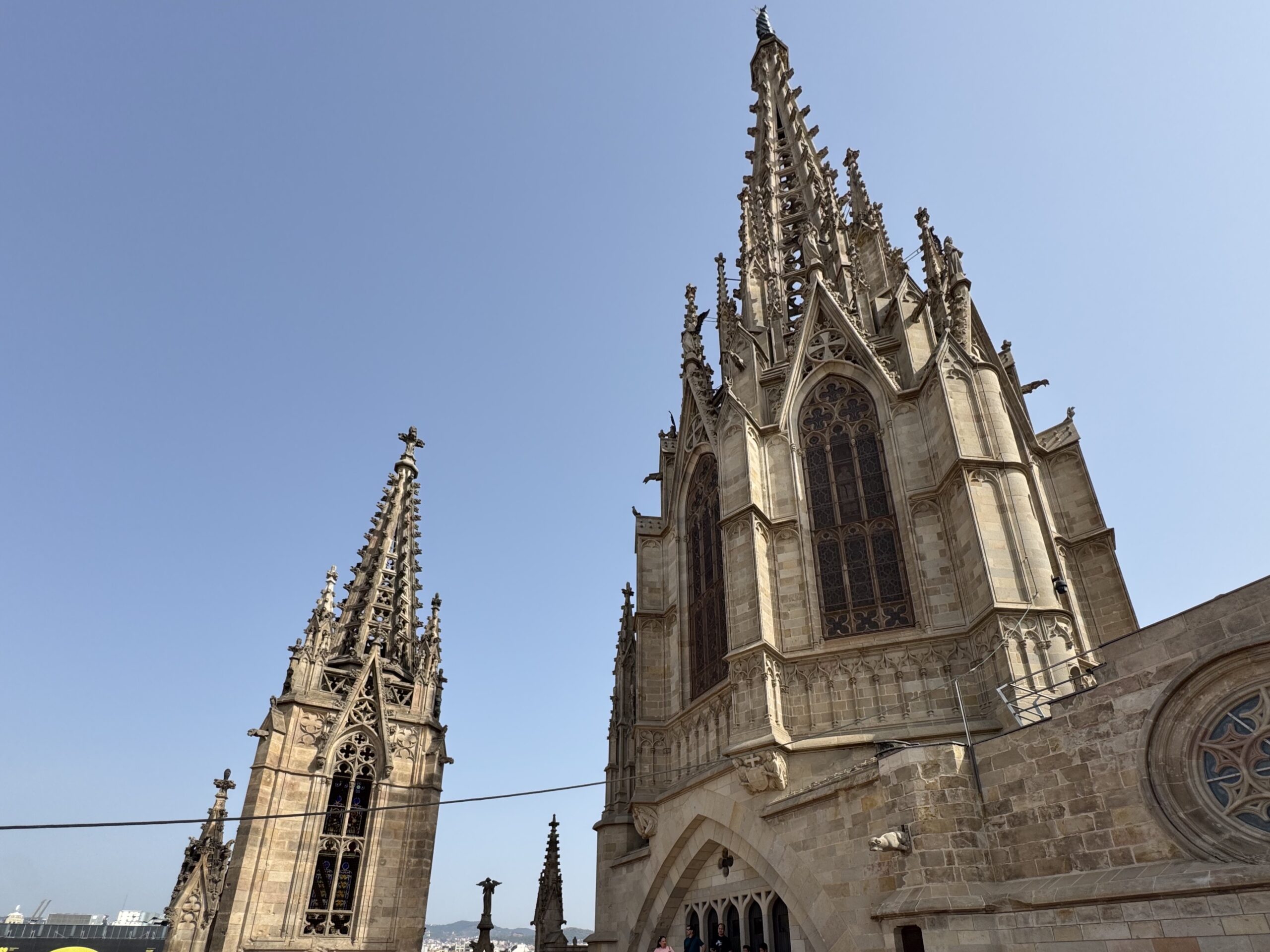 Gothic cathedral with ornate pinnacles reaching toward a clear blue sky.