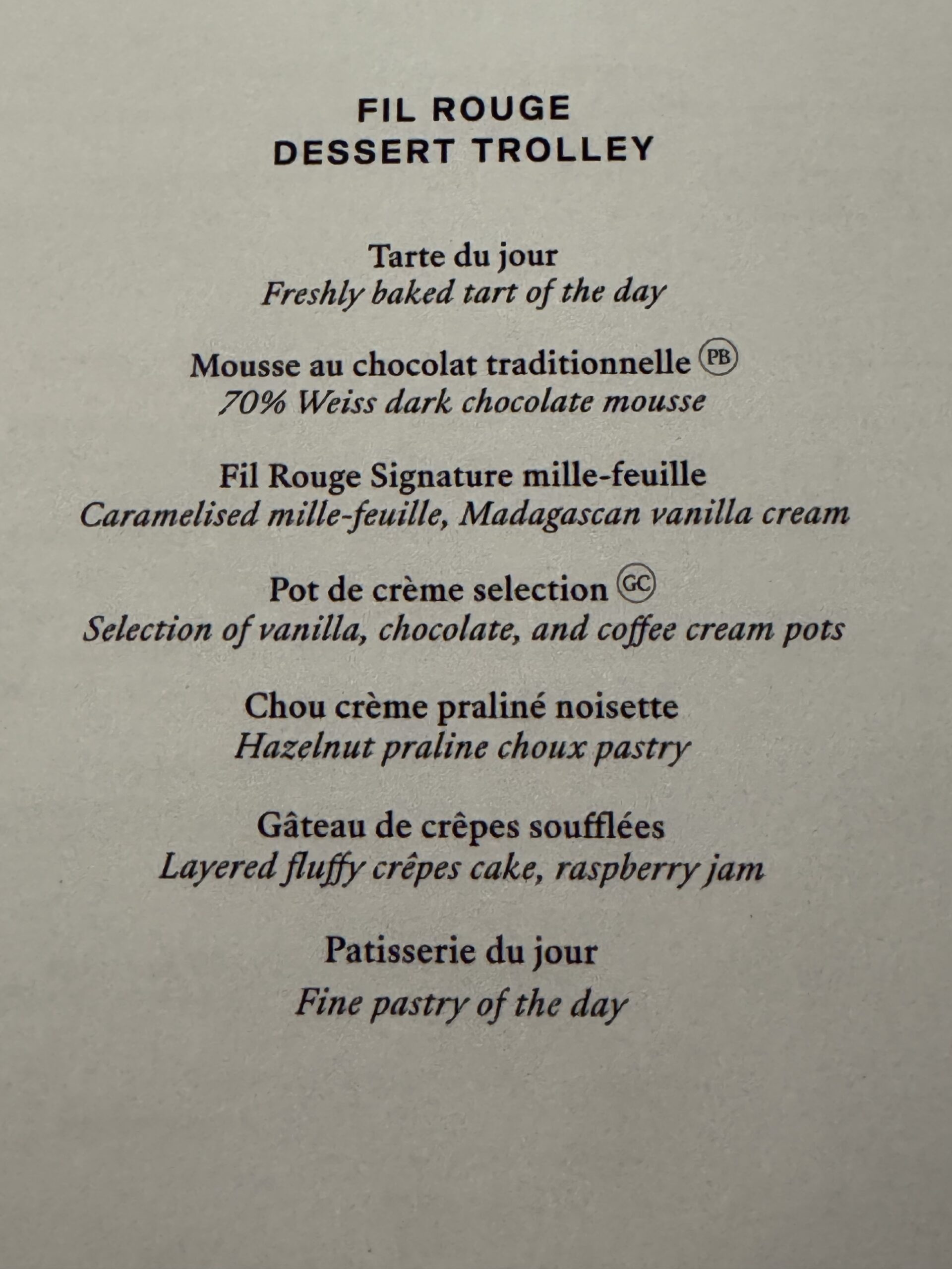 Menu page showing French dessert names and English translations: Tart du jour, Mousse au chocolat, Fil Rouge Signature mille-feuille, etc.